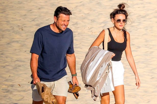 Michelle Keegan and Mark Wright in rare PDA as they kiss and cuddle while sunbathing on Sydney beach