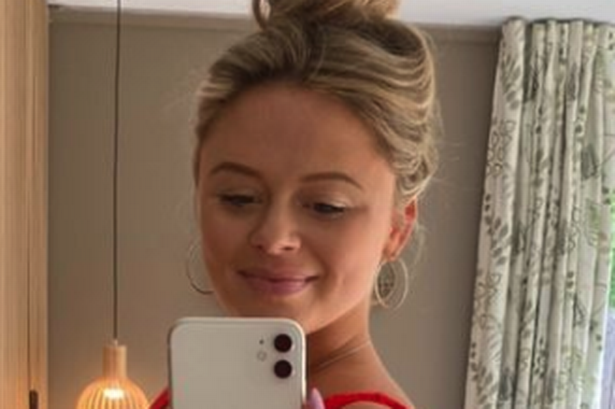 Pregnant Emily Atack cradles baby bump in plunging red swimsuit on countryside retreat